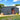 Gray metal shed with sliding doors